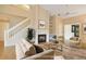 Comfortable living room featuring a cozy fireplace, plush seating, and a bright, open floor plan at 688 W Cranes Cir, Altamonte Springs, FL 32701