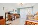 Bright bedroom featuring light blue walls, tile flooring, a daybed, and curtains at 702 Glasgow Ct, Winter Springs, FL 32708