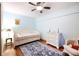 Charming bedroom with wood floors, a daybed, and a cozy sitting area at 702 Glasgow Ct, Winter Springs, FL 32708