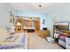 Cozy bedroom featuring light blue walls, tile flooring, daybed, and wicker furniture at 702 Glasgow Ct, Winter Springs, FL 32708