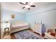 Charming bedroom with wood floors, a daybed, and a cozy sitting area at 702 Glasgow Ct, Winter Springs, FL 32708