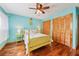 Bright bedroom featuring wood floors, a ceiling fan, and ample closet space, all creating a cozy retreat at 702 Glasgow Ct, Winter Springs, FL 32708