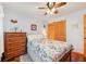 Bright bedroom features floral bedding, wood floors, and a built-in closet at 702 Glasgow Ct, Winter Springs, FL 32708