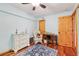 Welcoming bedroom with wood floors, vintage desk, and a cozy wicker chair at 702 Glasgow Ct, Winter Springs, FL 32708