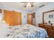 Comfortable bedroom with floral bedding, wood floors, and a built-in closet at 702 Glasgow Ct, Winter Springs, FL 32708