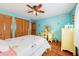 Inviting bedroom featuring a bright yellow vanity and closet providing ample storage and style at 702 Glasgow Ct, Winter Springs, FL 32708