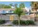 Exterior view showing the building facade and wooden fence with tropical trees at 702 Glasgow Ct, Winter Springs, FL 32708