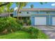 Inviting two-story townhouse featuring a private garage and lush landscaping at 702 Glasgow Ct, Winter Springs, FL 32708