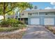 Charming two-story blue townhome with attached garage and mature landscaping at 702 Glasgow Ct, Winter Springs, FL 32708