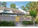 Exterior view showing the building facade and wooden fence with tropical trees at 702 Glasgow Ct, Winter Springs, FL 32708