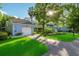 Charming blue two-story home with a well-manicured lawn and attached garage at 702 Glasgow Ct, Winter Springs, FL 32708