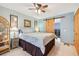 Bright bedroom featuring a ceiling fan, barn door, and adjacent laundry area at 702 Glasgow Ct, Winter Springs, FL 32708