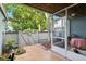 Enclosed patio featuring tiled flooring, screened enclosure, and access to outdoor garden at 702 Glasgow Ct, Winter Springs, FL 32708