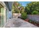 Outdoor patio bordered by a wooden fence and lush tropical landscaping, offers a private retreat at 702 Glasgow Ct, Winter Springs, FL 32708