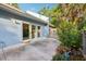 Charming patio, framed by tropical plants, extends from sliding glass doors, creating an inviting indoor-outdoor flow at 702 Glasgow Ct, Winter Springs, FL 32708
