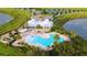 Breathtaking aerial view of the community clubhouse and pool, nestled amid serene lakes and lush landscaping at 7605 Lake Hancock Blvd, Winter Garden, FL 34787