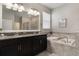 Elegant bathroom featuring a double vanity, soaking tub, and separate shower at 7605 Lake Hancock Blvd, Winter Garden, FL 34787