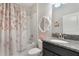 Bathroom featuring a white vanity with a granite countertop, a framed mirror and floral shower curtain at 7605 Lake Hancock Blvd, Winter Garden, FL 34787