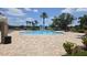 Inviting community pool area with a fountain, surrounded by lush greenery and ample seating at 7605 Lake Hancock Blvd, Winter Garden, FL 34787