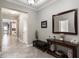 Grand foyer featuring neutral paint, ceramic tile floors, and a beautiful mirror and console table at 7605 Lake Hancock Blvd, Winter Garden, FL 34787