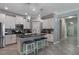 Modern kitchen with stainless steel appliances, island with seating, and stylish pendant lighting at 7605 Lake Hancock Blvd, Winter Garden, FL 34787
