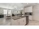 Open-concept kitchen flows into a comfortable dining and living area, perfect for Gathering gatherings at 7605 Lake Hancock Blvd, Winter Garden, FL 34787