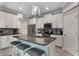 Well-equipped kitchen featuring an island with bar seating and stainless steel appliances at 7605 Lake Hancock Blvd, Winter Garden, FL 34787