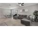 Comfortable living room featuring a large sectional sofa, ceiling fan, and ample natural light at 7605 Lake Hancock Blvd, Winter Garden, FL 34787