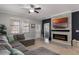 Spacious living area with fireplace, tv, and view to the front yard at 7605 Lake Hancock Blvd, Winter Garden, FL 34787
