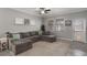 Comfortable living room features neutral paint, tile floors, and a large sectional sofa at 7605 Lake Hancock Blvd, Winter Garden, FL 34787