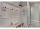 Mudroom with built-in bench, storage, and coat hooks at 7605 Lake Hancock Blvd, Winter Garden, FL 34787