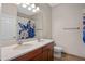 Bathroom with double vanity, butterfly shower curtain, and neutral walls at 8031 Enchantment Dr # Ge, Windermere, FL 34786