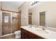 Bathroom featuring double sinks, tile flooring, and a glass-enclosed shower at 8031 Enchantment Dr # Ge, Windermere, FL 34786