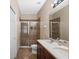 Bathroom featuring double sinks, tile flooring, and a glass-enclosed shower at 8031 Enchantment Dr # Ge, Windermere, FL 34786
