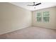 Neutral bedroom with carpet, ceiling fan, and dual window view of foliage at 8031 Enchantment Dr # Ge, Windermere, FL 34786