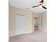 Bedroom featuring neutral walls, carpet, a ceiling fan, closet, and an adjoining room at 8031 Enchantment Dr # Ge, Windermere, FL 34786