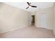 Bedroom featuring neutral walls, carpet, a ceiling fan, closet, and an adjoining room at 8031 Enchantment Dr # Ge, Windermere, FL 34786