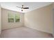 Cozy bedroom with large window offering natural light and neutral carpet at 8031 Enchantment Dr # Ge, Windermere, FL 34786