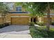 Charming townhouse featuring a two-car garage, manicured landscaping, and inviting front entrance at 8031 Enchantment Dr # Ge, Windermere, FL 34786