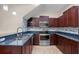 Modern kitchen featuring stainless steel appliances, granite countertops, and custom cabinetry with stylish backsplash at 8031 Enchantment Dr # Ge, Windermere, FL 34786