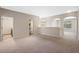 Spacious living room with neutral paint, carpet, and ample natural light at 8031 Enchantment Dr # Ge, Windermere, FL 34786