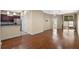 Open living space showcases wood floors, with a view to the kitchen and sliding door to a lanai at 8031 Enchantment Dr # Ge, Windermere, FL 34786