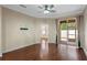 Bright living room with hardwood floors, ceiling fan, and sliding glass door leading to outdoor patio at 8031 Enchantment Dr # Ge, Windermere, FL 34786