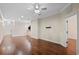 Bright living room with dark laminate floors and neutral walls, featuring a ceiling fan at 8031 Enchantment Dr # Ge, Windermere, FL 34786