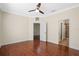 The main bedroom boasts wood floors, a ceiling fan, and an en-suite bathroom at 8031 Enchantment Dr # Ge, Windermere, FL 34786