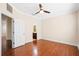 The main bedroom boasts wood floors, a ceiling fan, and an en-suite bathroom at 8031 Enchantment Dr # Ge, Windermere, FL 34786