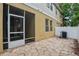 Enclosed patio area with white fencing, exterior entrance to a screened-in porch and tan-colored facade at 8031 Enchantment Dr # Ge, Windermere, FL 34786