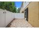 Enclosed rear patio with screen door and tan home exterior with white privacy fence at 8031 Enchantment Dr # Ge, Windermere, FL 34786
