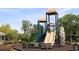 Community playground with slides, climbing structures, a bench, and shaded area at 8031 Enchantment Dr # Ge, Windermere, FL 34786
