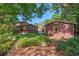 Beautiful backyard featuring brick pathway, lush landscaping, and detached garage or shed at 806 E Amelia St, Orlando, FL 32803
